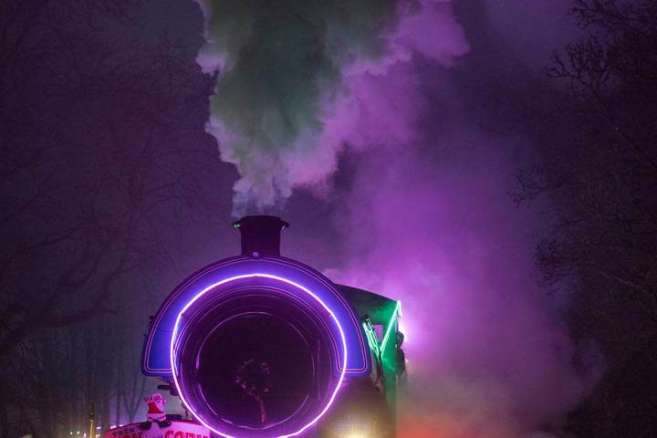 a train on a track with smoke coming out of it