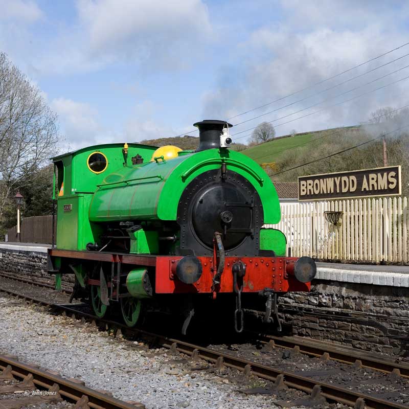 Olwen-2 a green train that is sitting on a track