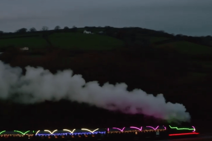 a train on a track with smoke coming out of it