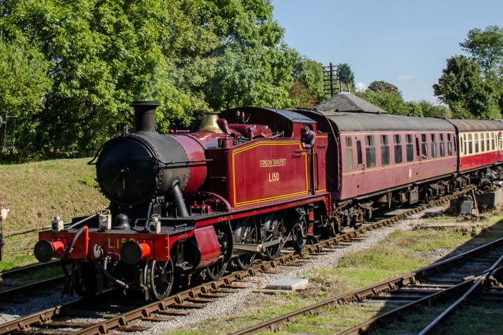 a train engine carrying carts down a track