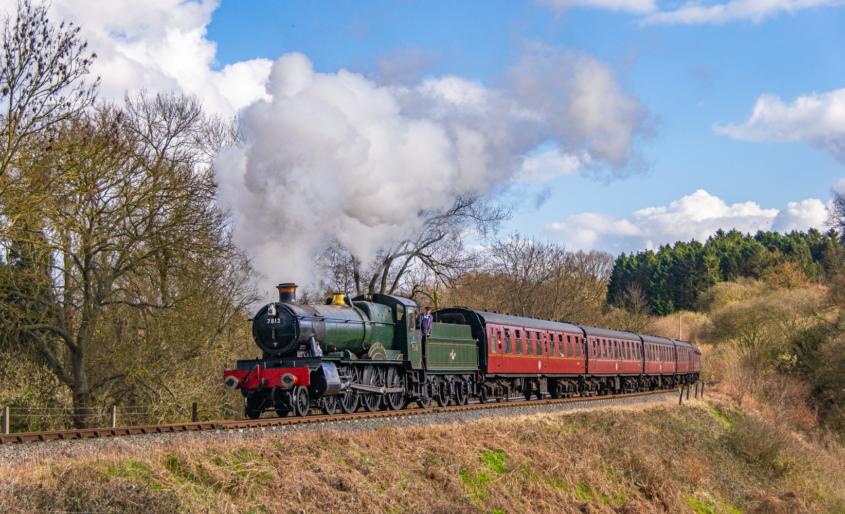 a train on a track with smoke coming out of it