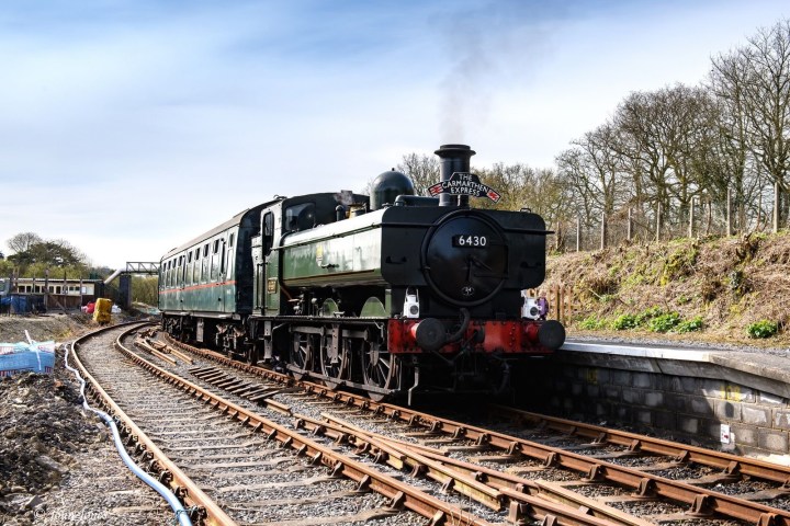 a steam engine train traveling down train tracks