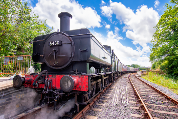 a steam engine is sitting on a train track