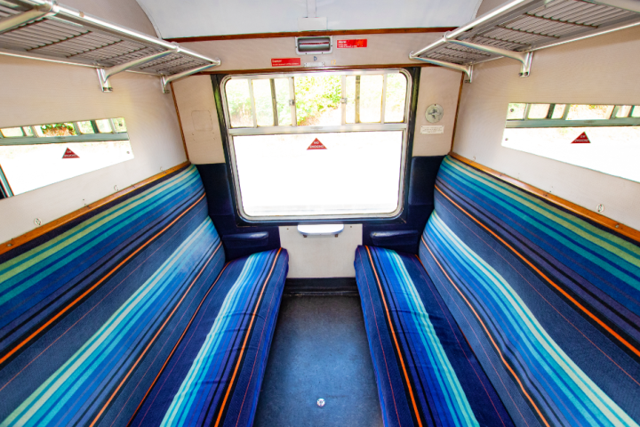 a bedroom with a bed and desk in a room